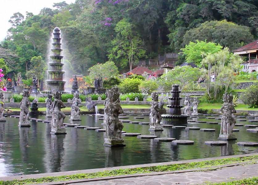 Main pond with statues and fountains of Tirta Gangga Water Palace