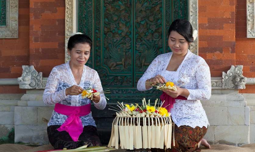 Two Balinese women demonstrating canang making