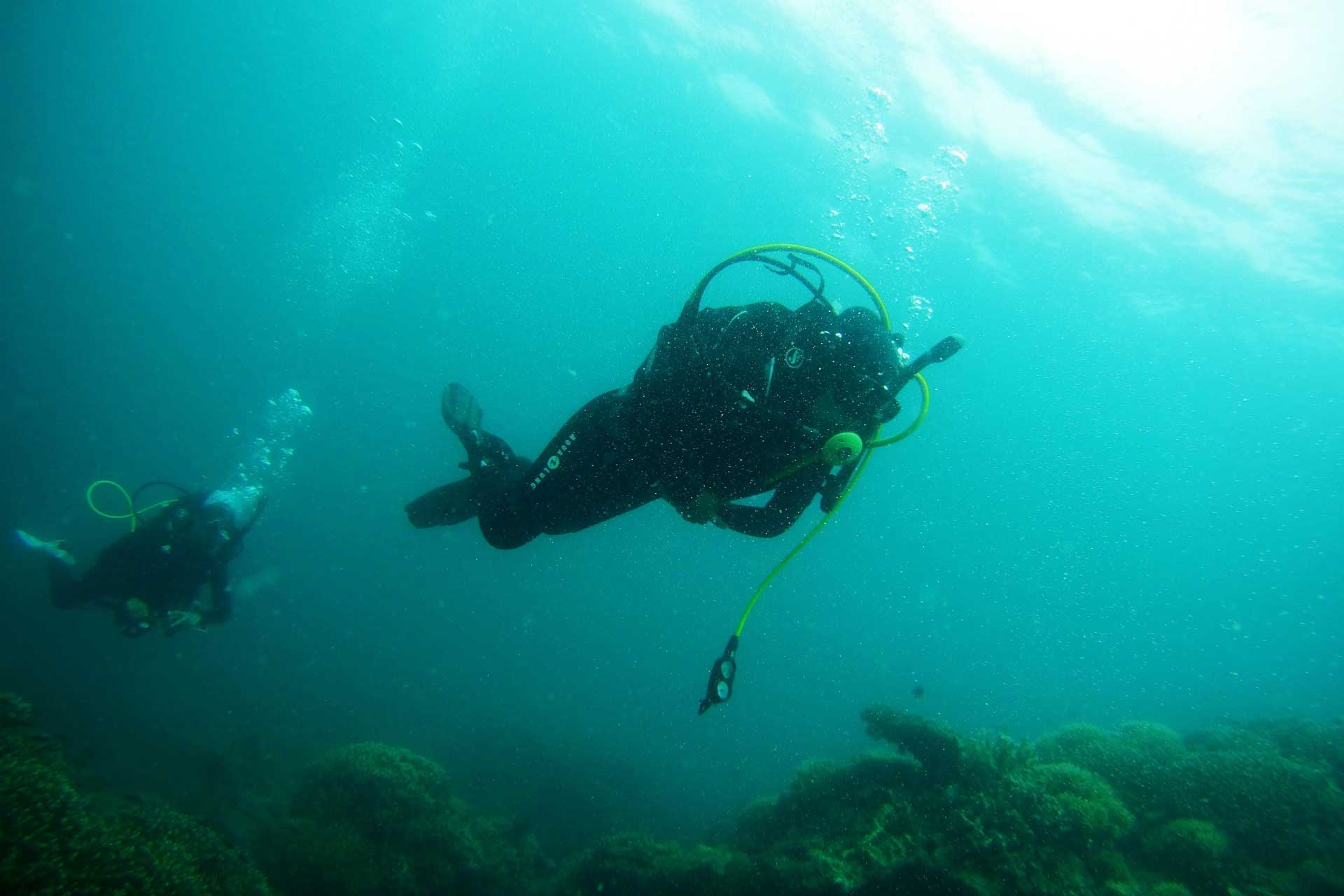Two divers diving off the coast of Puri Bagus Candidasa