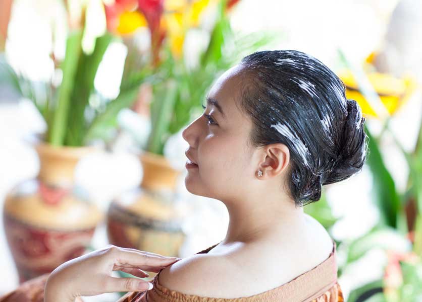 A lady undergoing scalp and hair treatment